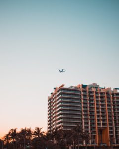 plane flying over hotel